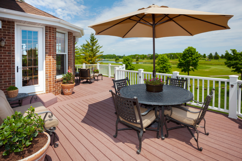 wooden deck with table, umbrella, chairs